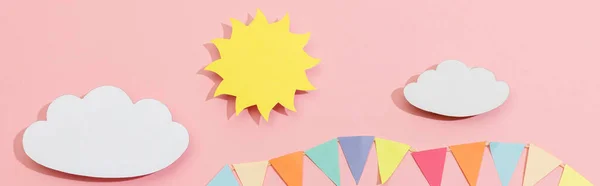 Top view of paper cut sun, clouds and flags on pink background, panoramic shot — Stock Photo