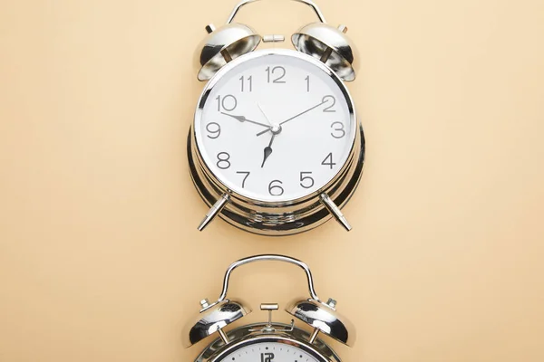 Top view of classic alarm clock on beige background — Stock Photo