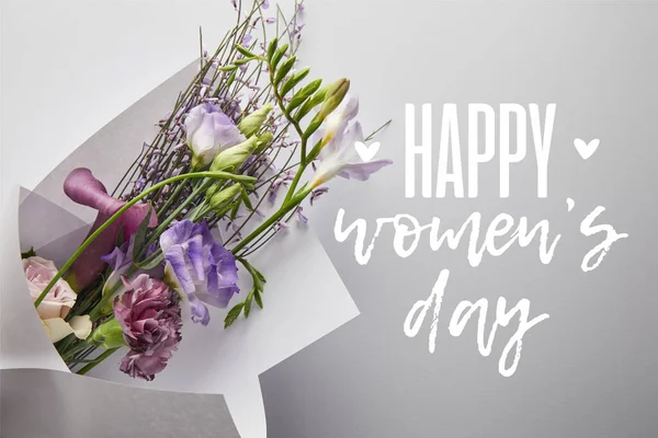 Top view of violet bouquet wrapped in paper on white background, happy womens day illustration — Stock Photo