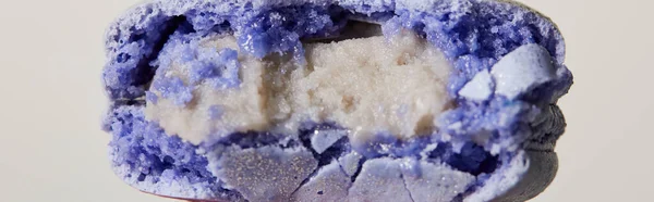 Close up view of purple delicious bitten colorful french macaroon isolated on white, panoramic shot — Stock Photo