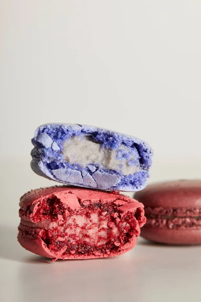 Selective focus of assorted delicious bitten colorful french macaroons on white background — Stock Photo