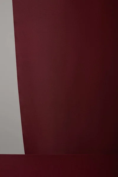 Бургундская мягкая текстурированная ткань, изолированная на сером — стоковое фото