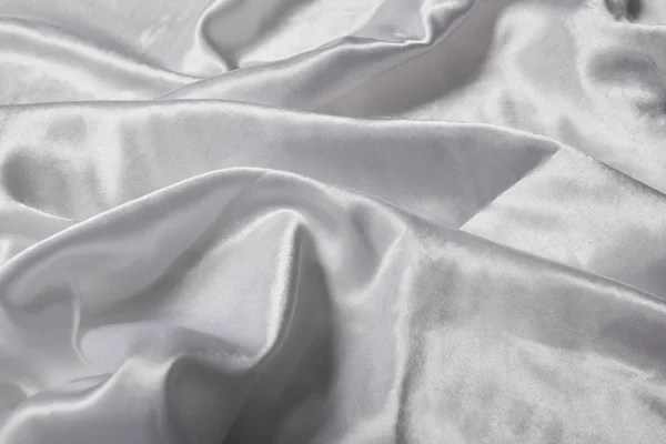 Vista de cerca de tela blanca suave y arrugada con textura de seda - foto de stock