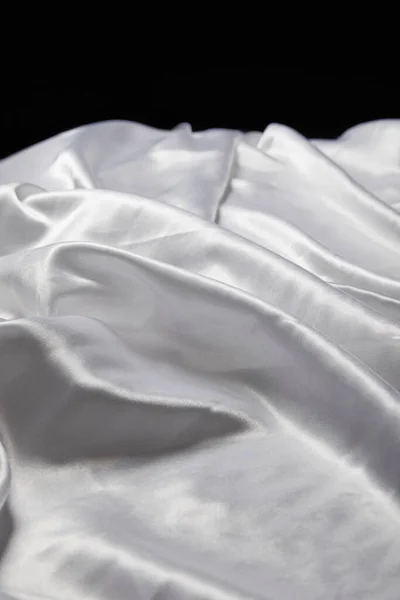 Close up view of white soft and crumpled silk textured cloth isolated on black — Stock Photo