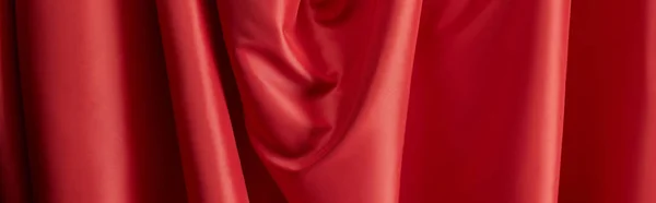 Close up view of red soft and wavy silk textured cloth, panoramic shot — Stock Photo