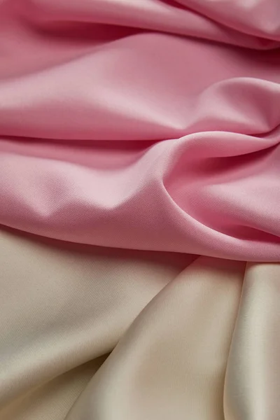 Close up view of satin pink and white soft and wavy fabric — Stock Photo