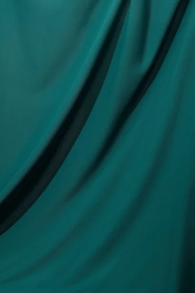 Close up view of emerald soft and wavy silk fabric — Stock Photo