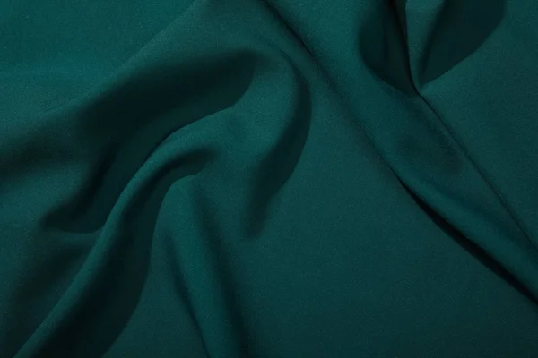 Close up view of emerald soft and wavy silk fabric — Stock Photo