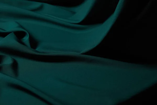 Close up view of emerald soft and wavy silk fabric — Stock Photo