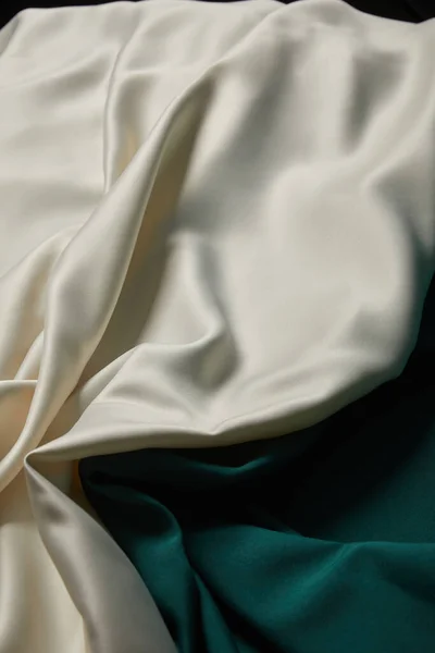 Close up view of emerald and white soft and wavy silk fabric — Stock Photo