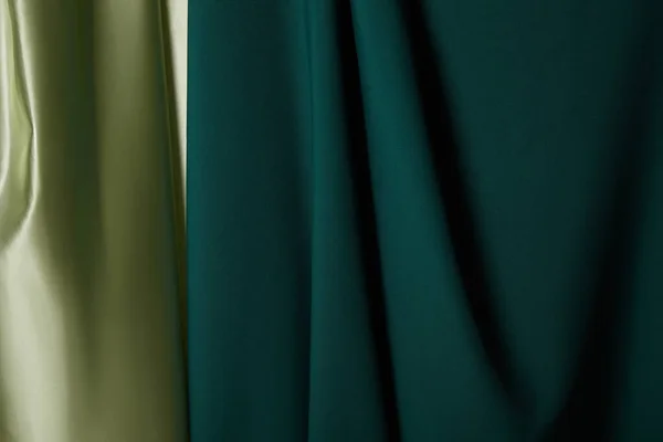 Close up view of emerald, light green soft and wavy silk fabric — Stock Photo