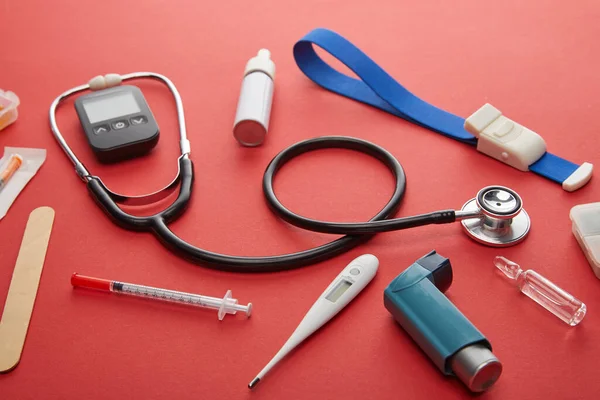 High Angle View of medical objects on red background — Stock Photo