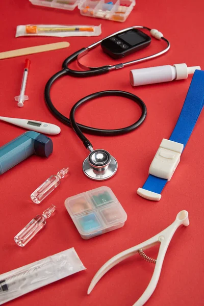 Selective focus of medical objects on red background — Stock Photo