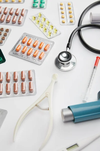 High angle view of medical objects and pills on white background — Stock Photo