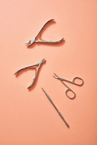 Top view of manicure instruments on coral background — Stock Photo