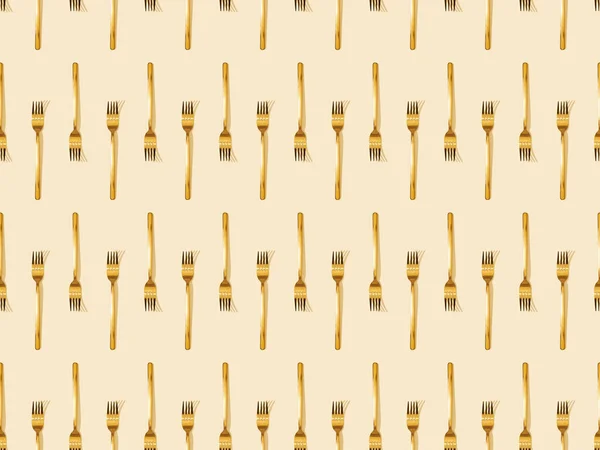 Vista dall'alto di forchette dorate isolate su sfondo beige, senza cuciture — Stock Photo