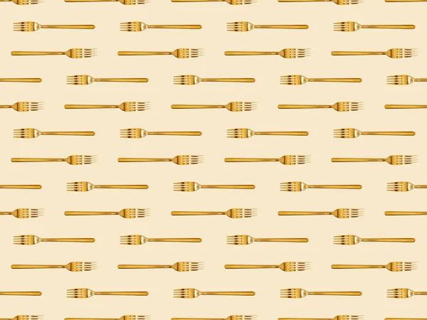 Top view of golden forks isolated on beige, seamless background pattern — Stock Photo