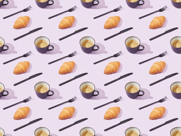 Black forks and knives, croissants and coffee on violet, seamless background pattern — Stock Photo
