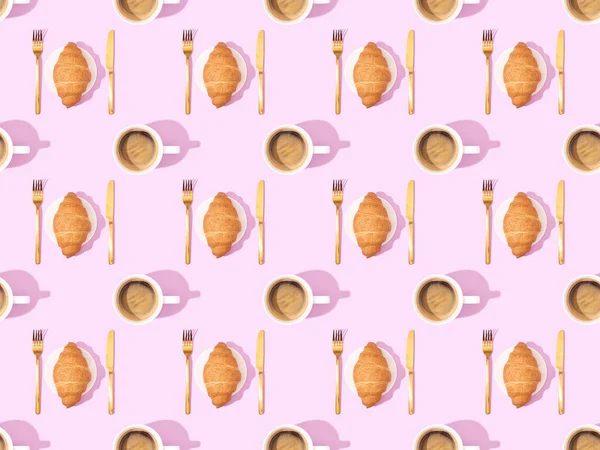 Top view of cutlery, croissants on plates and coffee on pink, seamless background pattern — Stock Photo