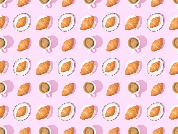 Top view of croissants and coffee on pink, seamless background pattern — Stock Photo