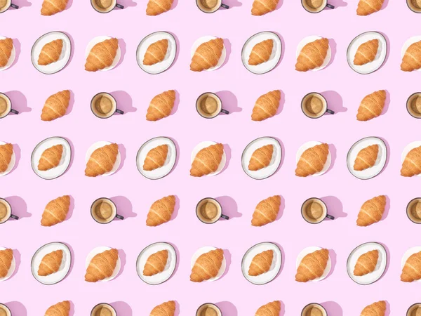 Top view of croissants and coffee on pink, seamless background pattern — Stock Photo