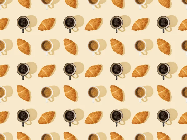 Vue de dessus des croissants et du café sur fond beige, motif sans couture — Photo de stock