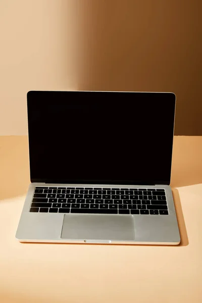 Opened laptop with blank screen on beige background — Stock Photo