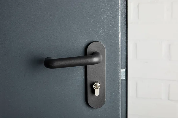 Clean metal door with black handle after disinfection — Stock Photo