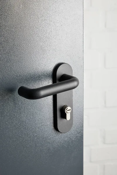 Clean metal door with black handle after disinfection — Stock Photo