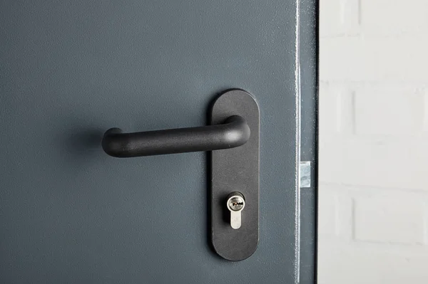 Clean metal door with black handle after disinfection — Stock Photo