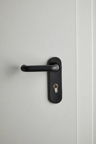 Clean grey metal door with black handle after disinfection — Stock Photo