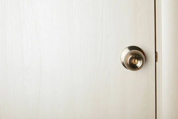 Clean white wooden door with metal handle after disinfection — Stock Photo