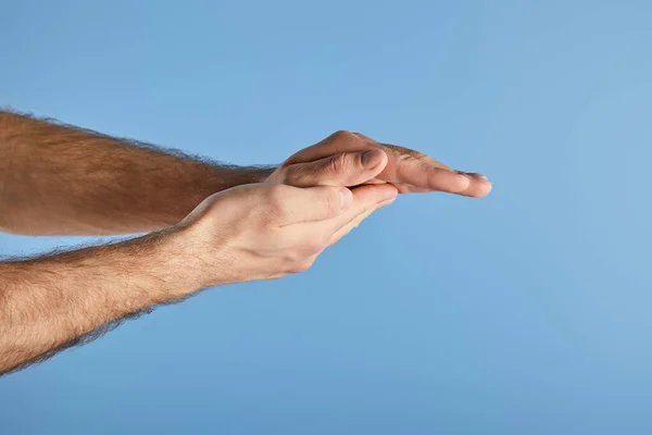 Partial view of man washing hands isolated on blue — Stock Photo