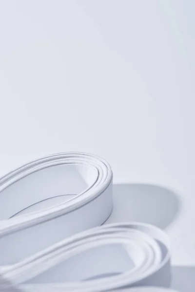Close up vista de listras de papel curvo no fundo branco — Fotografia de Stock