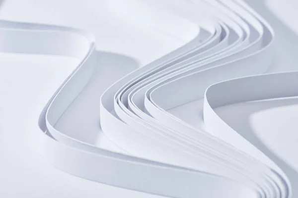 Close up view of wavy paper stripes on white background — Stock Photo