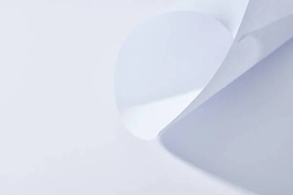 Close up view of curved paper sheet on white background — Stock Photo