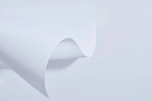 Close up view of curved paper sheet on white background — Stock Photo