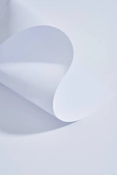 Close up view of curved paper sheet on white background — Stock Photo