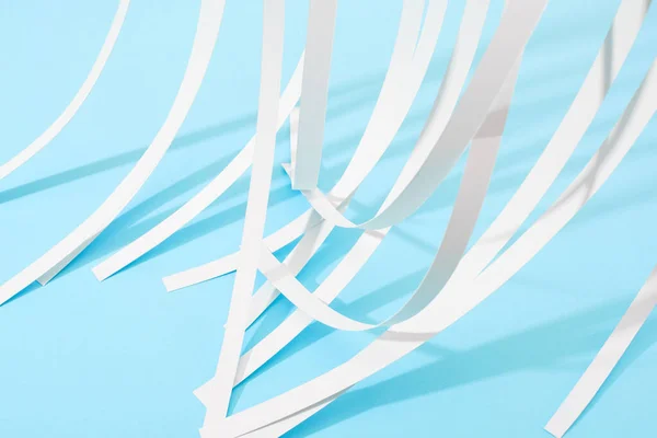 Close up view of white paper stripes on blue background — Stock Photo