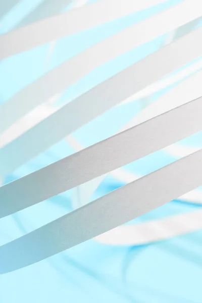 Close up view of white paper stripes on blue background — Stock Photo