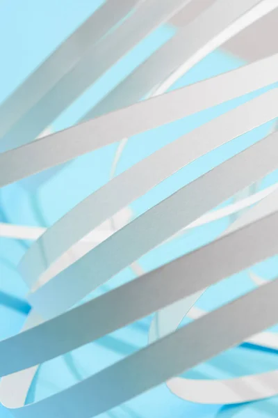 Close up view of white paper stripes on blue background — Stock Photo