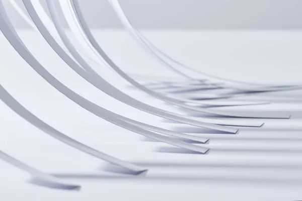 Close up view of curved paper stripes on white surface — Stock Photo