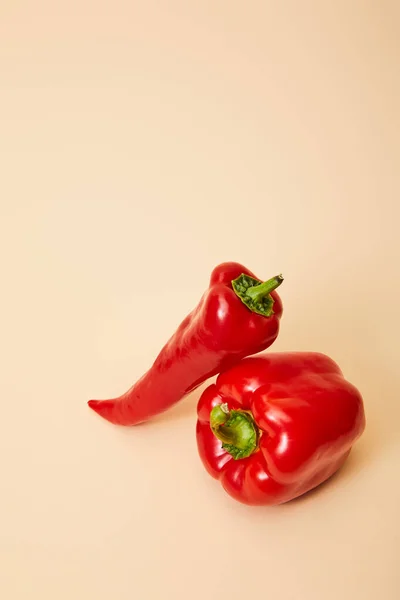 Chili and bell peppers on beige with copy space — Stock Photo