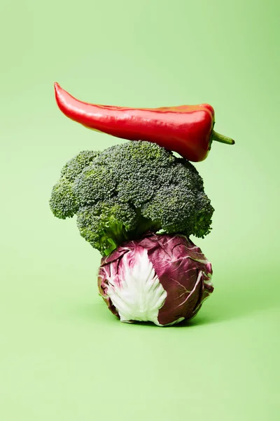 Chili pepper, broccoli and red chinese cabbage on green — Stock Photo