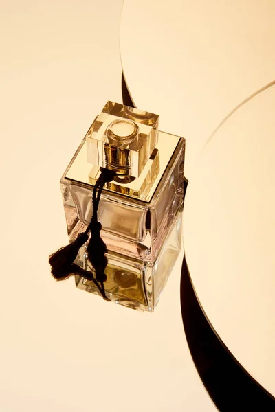 High angle view of perfume bottle on round mirror surface — Stock Photo