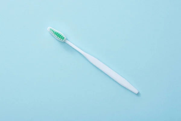 Top view of white toothbrush on blue background — Stock Photo