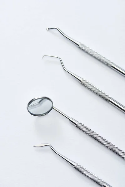 High angle view of professional dental examination instruments on grey background — Stock Photo