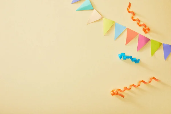 Top view of festive colorful confetti on beige background — Stock Photo