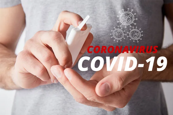 Cropped view of adult man using hand sanitizer, coronavirus illustration — Stock Photo