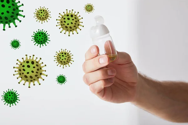 Cropped view of man holding hand sanitizer on grey background, bacteria illustration — Stock Photo